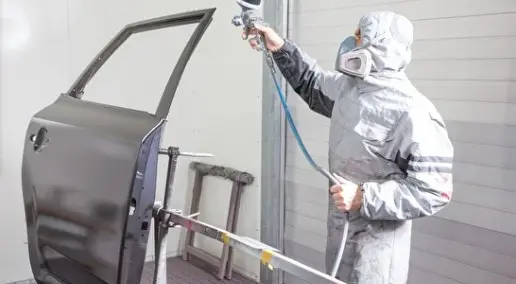 Professionally painting a car with a new name for a new body